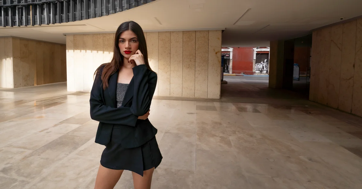 Mujer elegante en atuendo negro posando con estilo en Mérida, México.